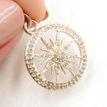 Load image into Gallery viewer, A hand holding a sterling silver round sun pendant with black rhodium and rose gold plating, encrusted with small diamonds.
