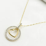 Load image into Gallery viewer, 14K Solid Gold Diamond Circle Charm with Heart in the Center. EJP1496