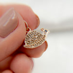 Load image into Gallery viewer, A sterling silver snail charm with black rhodium and gold plating, adorned with pave set diamonds and a small gemstone.