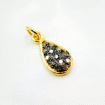 Load image into Gallery viewer, A teardrop-shaped sterling silver charm with black rhodium and gold plating, covered in small embedded diamonds.
