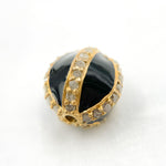 Load image into Gallery viewer, A round enamel bead with black rhodium and gold plating, encrusted with diamonds.