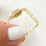 Load image into Gallery viewer, A gold-plated, black rhodium and gold-plated square enamel carabiner clasp with diamond accents, held between fingers.