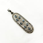 Load image into Gallery viewer, A collection of oval-shaped pendants with gemstones and diamond accents, featuring variations in black rhodium, gold plating, and gemstone colors.
