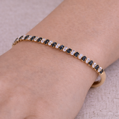 BNK68620A. 14K Solid gold bangle alternating black diamonds and white diamonds