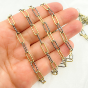Black Rhodium and Gold Plated 925 Sterling Silver Paperclip Chain on a person's wrist.